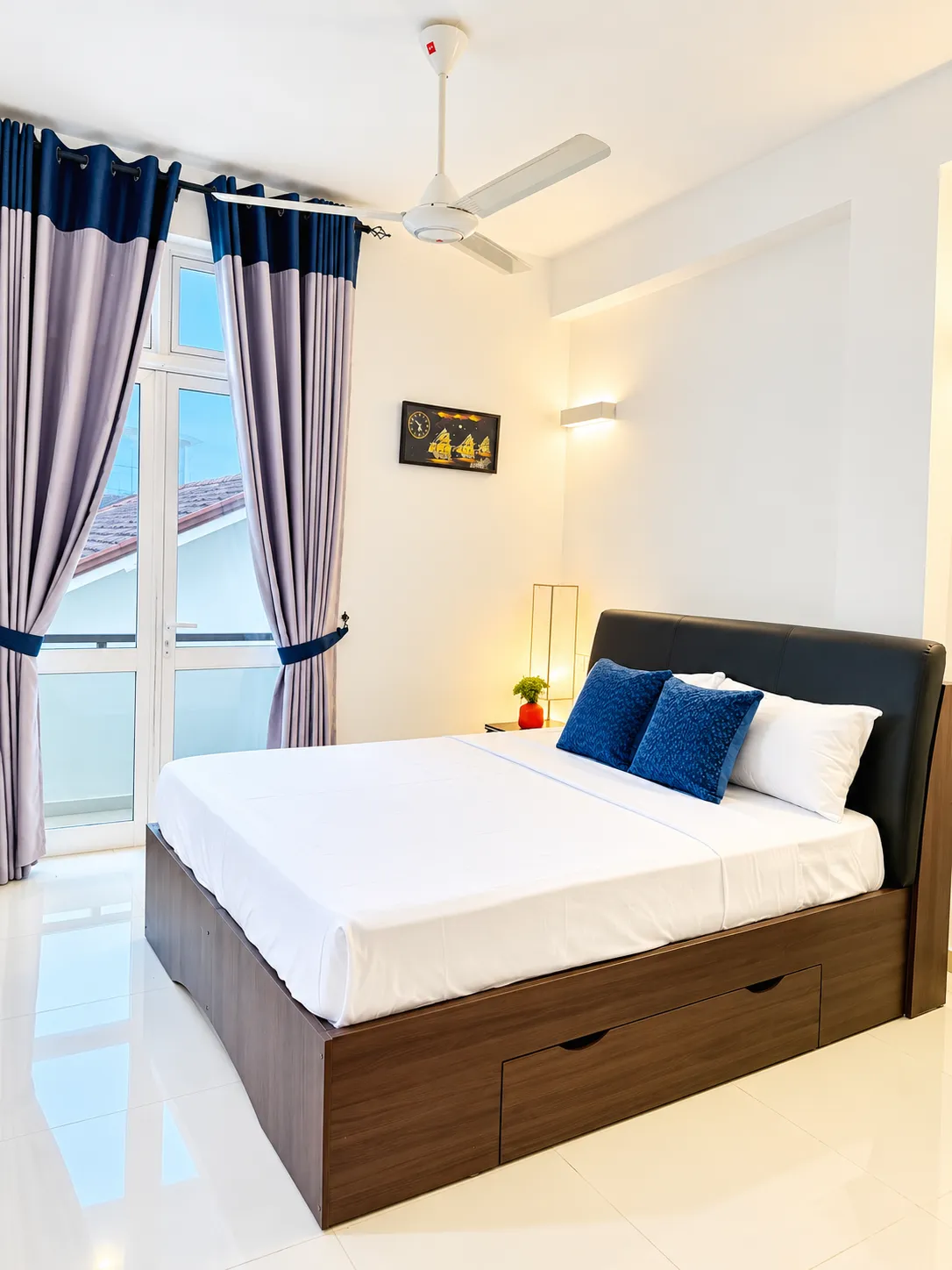 Guest bedroom with balcony doors at The Residence by Hanz