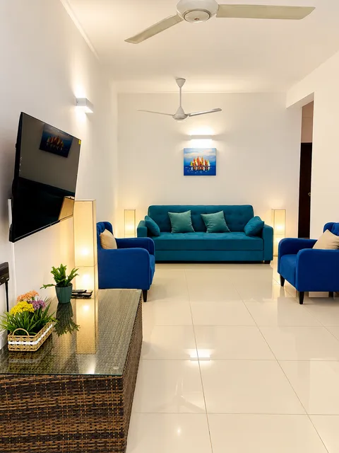 View through the living room towards the blue sofa